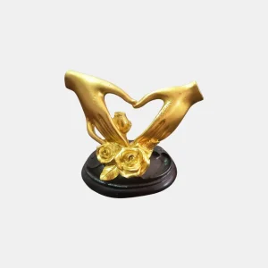 Celebrate love and togetherness with this elegant Golden Love Hand Heart Showpiece. Crafted from durable resin material, this romantic sculpture features two beautifully sculpted golden hands forming a heart shape, symbolizing affection, unity, and everlasting bonds. The base is accented with delicate roses, making it perfect as a gift or a stylish décor item.