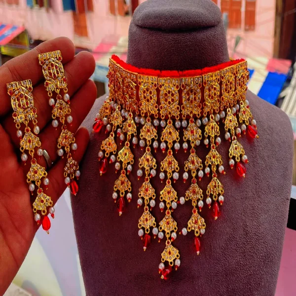 Jadau Raani Haar, a masterpiece that reflects the rich heritage of Indian royalty. Handcrafted by skilled artisans, this exquisite necklace features intricate Kundan and Polki work, adorned with precious stones and pearls that bring out its regal charm.