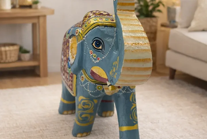 Bring home the charm of traditional Indian craftsmanship with this beautifully handcrafted wooden elephant showpiece. Carefully carved from premium quality wood and hand-painted by skilled artisans, this decorative figurine showcases intricate detailing and vibrant ethnic patterns. The elephant is widely regarded as a symbol of good luck, wisdom, and prosperity, making this showpiece an excellent addition to your home décor or a thoughtful gift for loved ones. Its durable construction and artistic finish make it suitable for long-term use while adding a cultural and elegant touch to any space. Perfect for decorating your living room, office, bedroom, pooja room, or display shelves, this wooden elephant figurine effortlessly enhances the aesthetic appeal of your interiors.