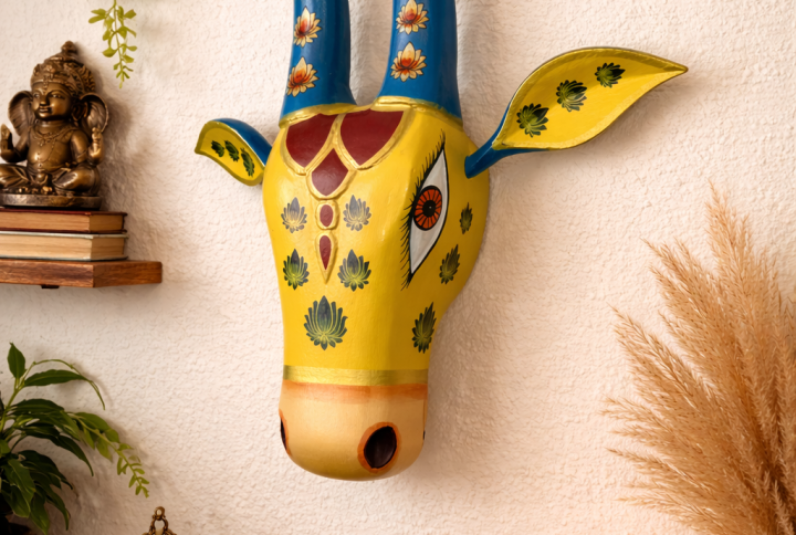 Handcrafted Design: Expertly handcrafted cow head wall hanging inspired by traditional Indian art and culture. Hand-Painted Finish: Decorated with vibrant, long-lasting colors and detailed artwork for an elegant look. Perfect Home Décor: Ideal for living room, pooja room, entrance, office, or any interior wall space. Easy to Hang: Lightweight construction with a convenient hanging provision for quick installation. Ideal for Gifting: A thoughtful choice for housewarming, festive occasions, weddings, and special celebrations. Size: Approx. 15 inch height (minor variations may occur due to handcrafted nature).